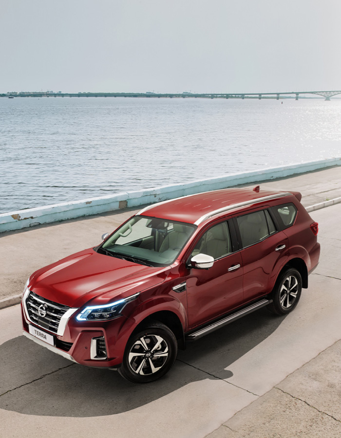 Red Terra on concrete road next to coast line