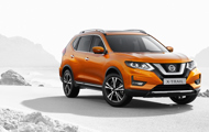 Orange Nissan X-Trail on a road in-front of sea