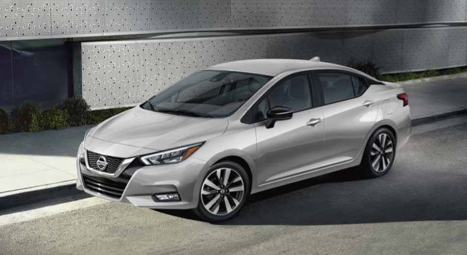 Silver Nissan Sunny parked in front of a building