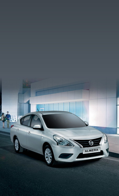 White Almera parked in front of building