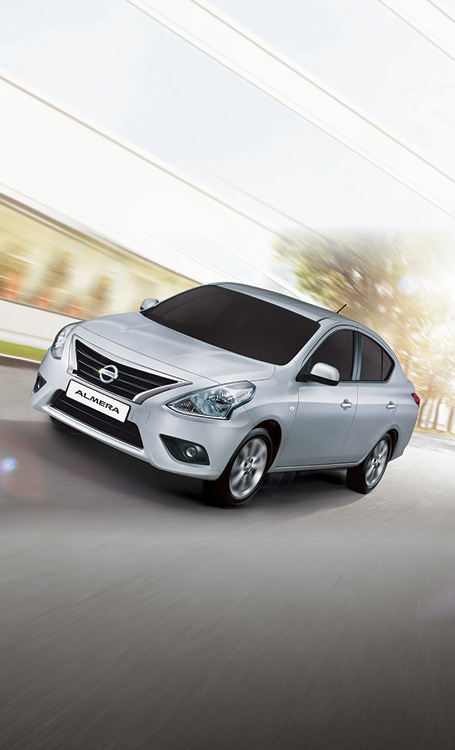 Silver Almera driving in the suburbs 