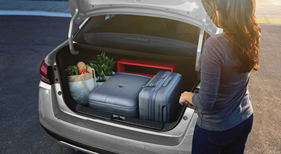Open boot of Nissan Sunny with luggage and groceries