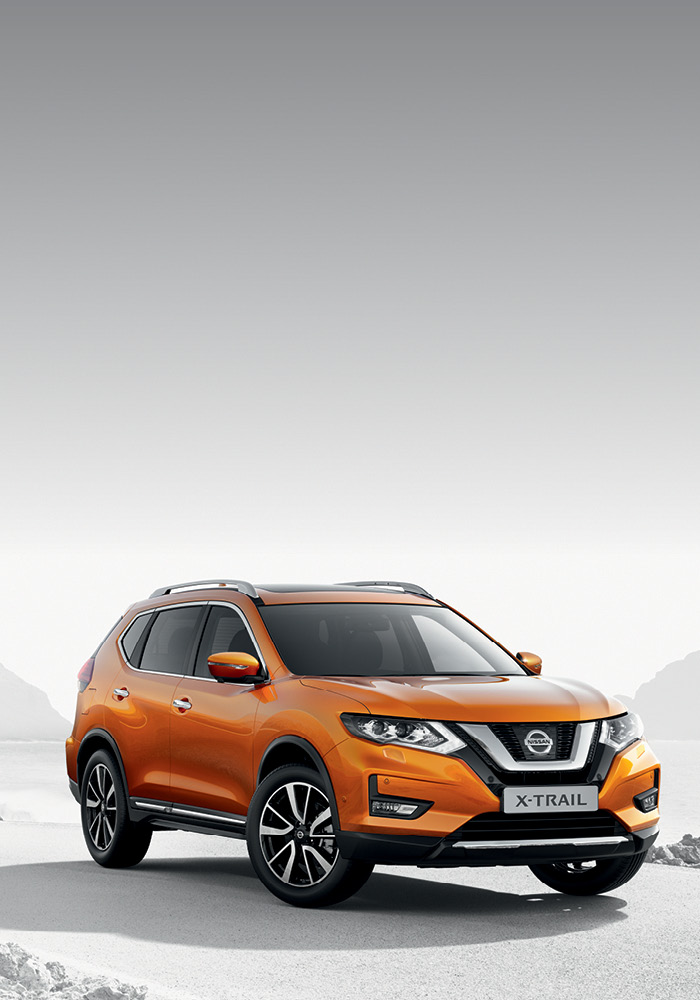 Orange Nissan X-Trail on a road in-front of sea